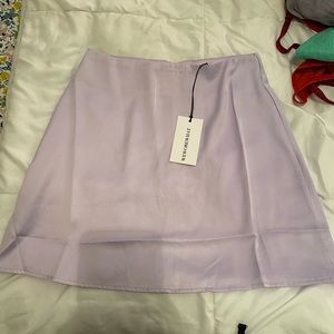 New with tags satin heather purple skirt. We wore what